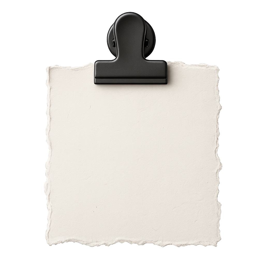 A matte-black bulldog clip pinching cream paper that holds the studio manifesto